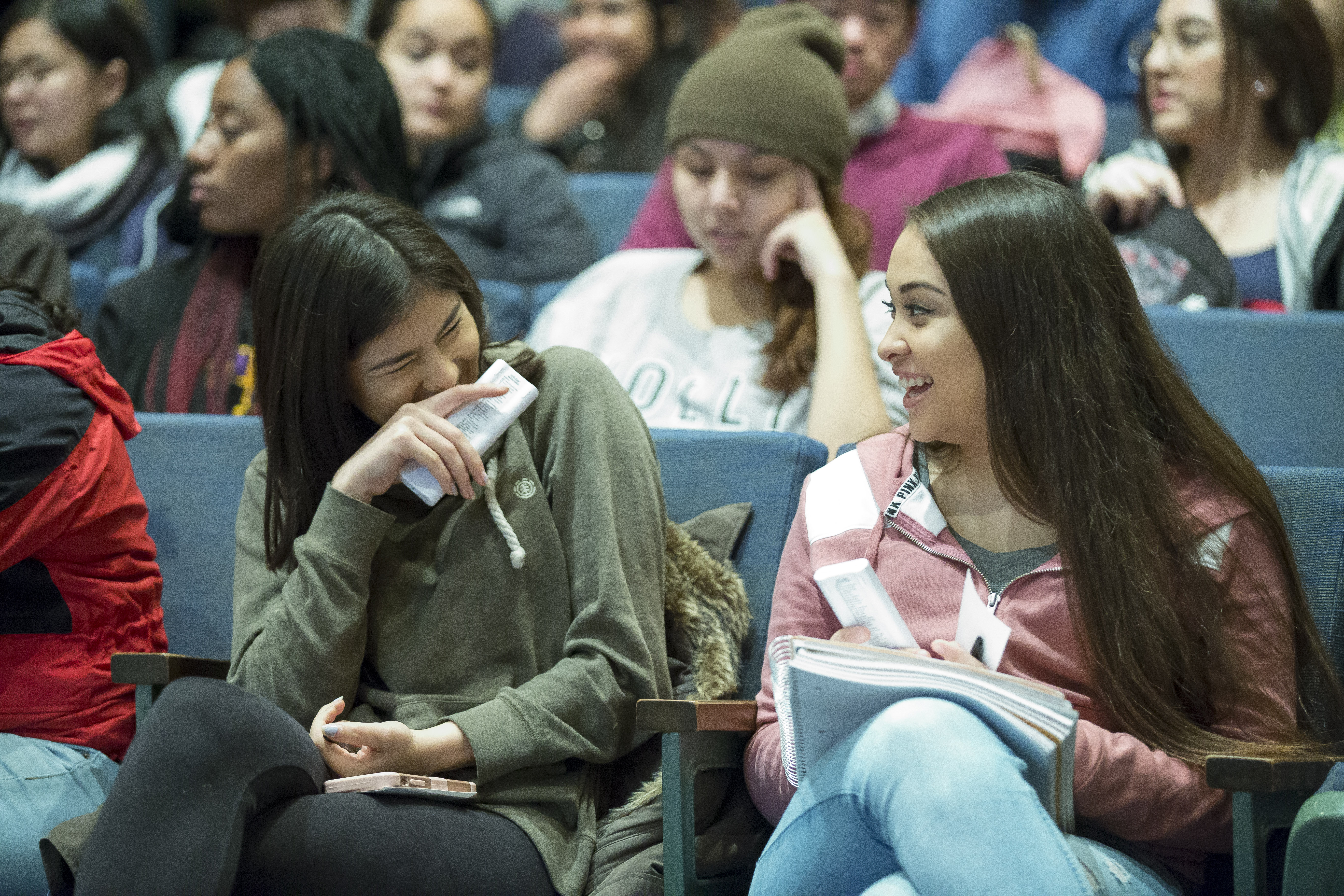 Students converse in a lecture room